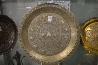 A good Indian embossed metal dish with incised decoration.