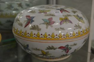 A large Chinese circular bowl and cover decorated with butterflies.