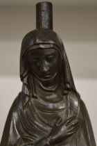 A cast bronze figure of a penitent lady.