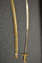 A highly ornate Eastern brass sword and scabbard, the gilded scabbard decorated with turquoise
