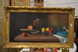 Still life of fruit and books on a table, oil on board in a decorative gilt frame.