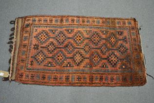 A small Persian rug or wall hanging 117cm x 62cm.