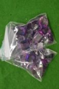 A collection of small bags containing colourful stones.