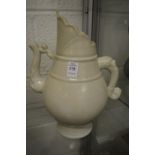 A large pale celadon glazed Chinese ewer.