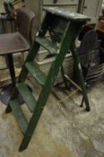 An old green painted wooden step ladder.