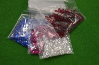 Various bags of coloured spinels.