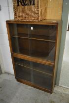 A bookcase with sliding glass door.