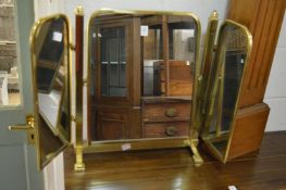 A heavy brass framed dressing table mirror.