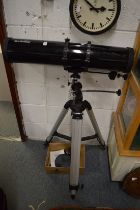 A Sky-Watcher astronomical telescope with tripod and accessories.