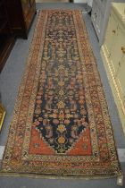 Early Persian runner, blue ground with stylised decoration, signed, 406cm x 112cm.