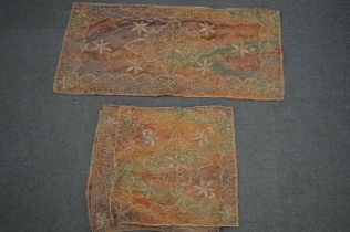 A gold thread embroidered table runner with six matching squares.