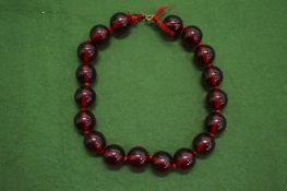 A cherry amber style bead necklace.