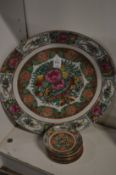 A Chinese famille rose circular dish and nine similar smaller dishes.