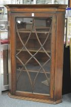 A George III mahogany hanging corner cabinet.