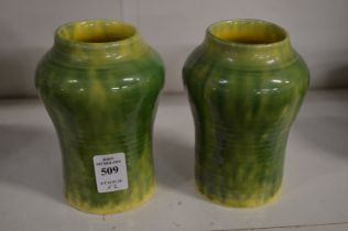 Two small green glazed vases.