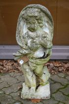 A reconstituted stone garden ornament modelled as a cherub.