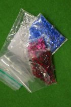 Various bags of coloured spinels.