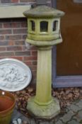 An unusual reconstituted stone pedestal bird table.