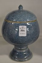 A Chinese mottled blue glazed pedestal bowl and cover.