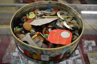 An old tin containing a quantity of buttons.