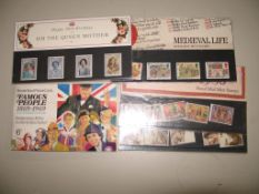 An album of cigarette cards & four commemorative stamp packets (Q).