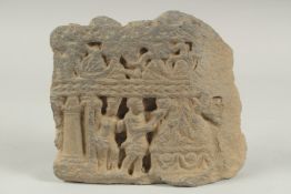 A RARE GANDHARA CARVED GREY SCHIST STONE TILE FRAGMENT, depicting two men around a ceremonial