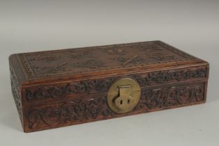 A CHINESE CARVED HARDWOOD BOX, the hinged lid carved with precious objects, 32cm x 18cm.