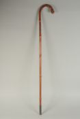 A CHINESE BAMBOO WALKING STICK, carved with female figure and serpent, inscribed /signed to lower