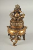 A SOUTH EAST ASIAN GILDED WHITE METAL TRIPOD CENSER AND COVER, character mark to base, 20cm high.