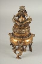 A SOUTH EAST ASIAN GILDED WHITE METAL TRIPOD CENSER AND COVER, character mark to base, 20cm high.