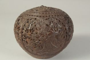 AN INDIAN CARVED OPENWORK COCONUT.