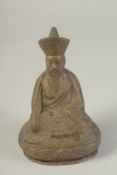 A CHINESE BRASS SEATED FIGURE, 15cm high.