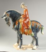 A LARGE CHINESE TANG STYLE GLAZED POTTERY HORSE AND RIDER, 39cm long.