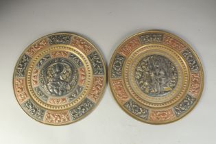 TWO INDIAN TANJORE SILVER AND COPPER INLAID BRASS DISHES, 31cm diameter.