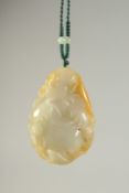 A CHINESE CARVED JADE PENDANT, 5cm x 3.5cm.