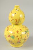 A CHINESE YELLOW GROUND POLYCHROME DOUBLE GOURD VASE, 24cm high.