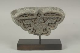A FINE 14TH CENTURY PERSIAN TIMURID CARVED GREY SCHIST STONE FRAGMENT, on a later stand, 22cm wide.