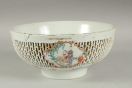 A LARGE CHINESE EXPORT FAMILLE ROSE PIERCED PORCELAIN BOWL, the openworked exterior with three