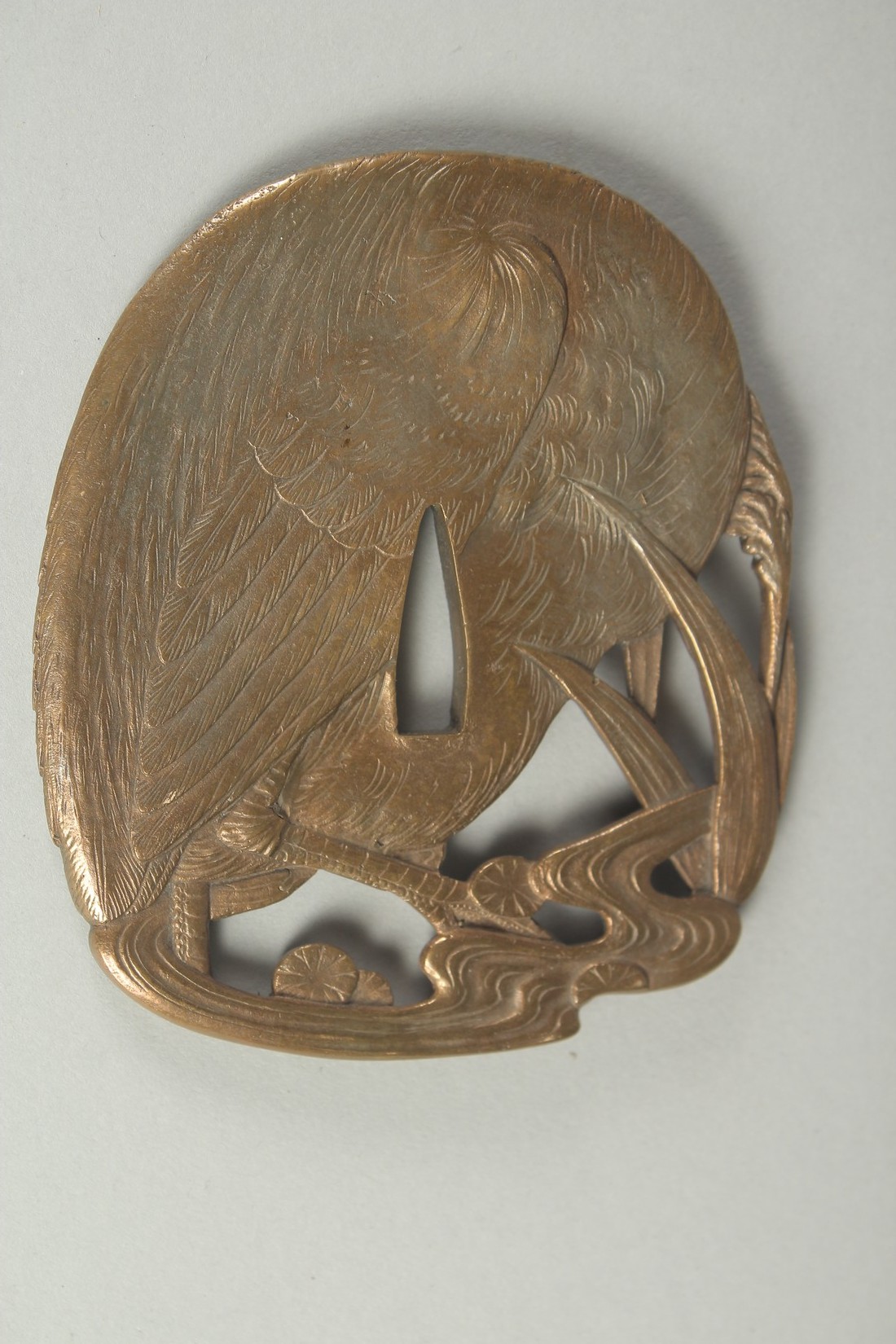 A JAPANESE ENGRAVED BRASS OPENWORKED TSUBA, designed with an egret, 9.5cm x 8cm. - Image 2 of 2