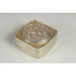 A SMALL SIGNED JAPANESE WHITE METAL AND BRASS BOX, the hinged lid with relief dragon roundel, 5cm