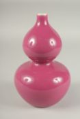 A CHINESE MONOCHROME PINK PORCELAIN DOUBLE GOURD VASE, character mark to base, 24cm high.