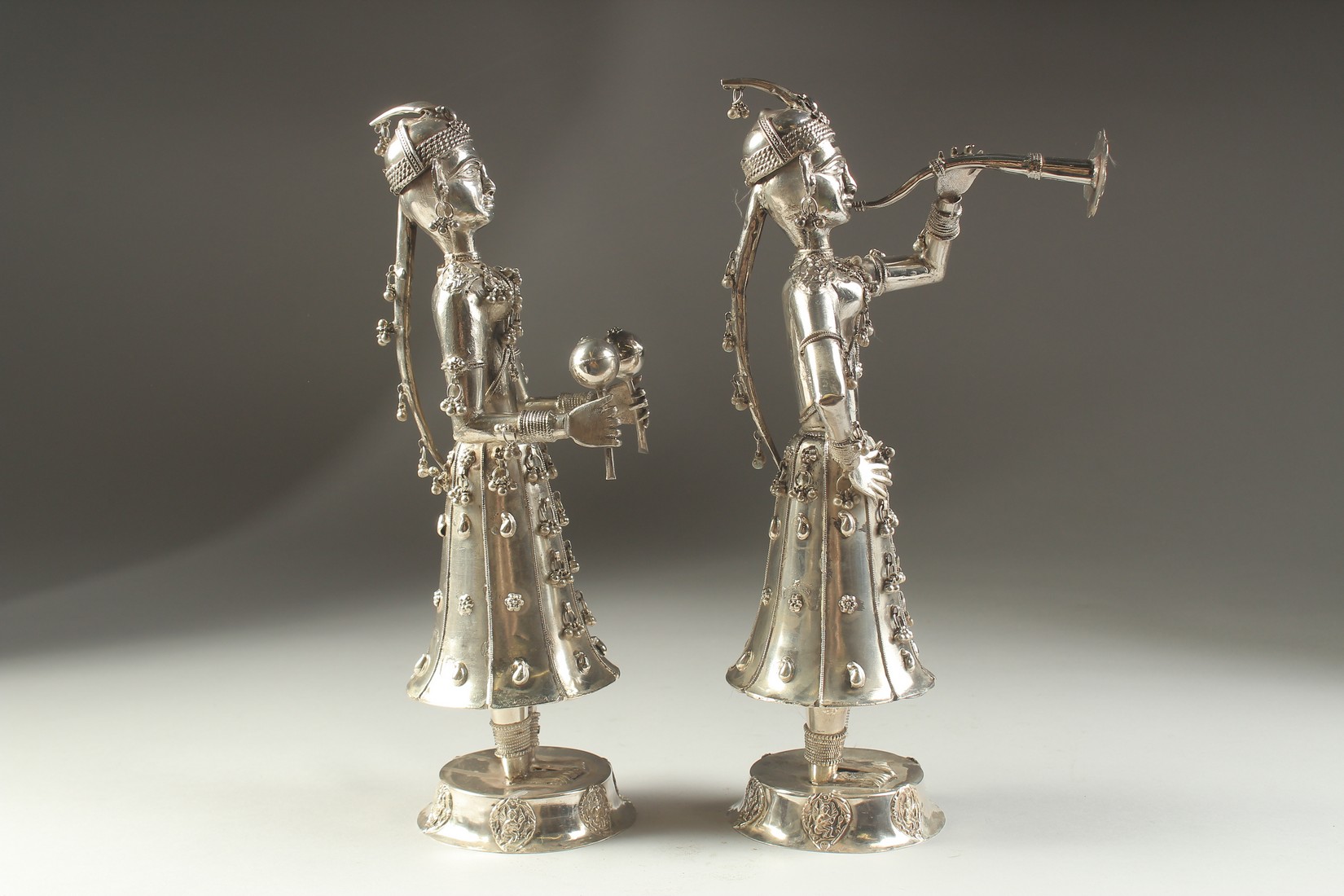 A FINE PAIR OF 19TH CENTURY INDIAN SILVER FIGURES OF MUSICIANS, 30cm high. - Image 8 of 11