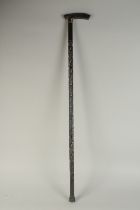 A CEYLONESE CARVED EBONY WALKING STICK WITH RHINO HORN HANDLE, 89cm high.