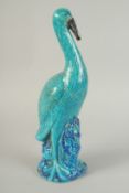 A LARGE CHINESE TURQUOISE / BLUE GLAZED POTTERY CRANE, 39.5cm high.