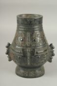 A CHINESE CARVED HARDSTONE TWIN HANDLE VASE, with archaic style designs, 21.5cm high.