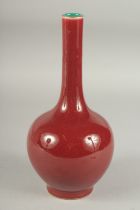 A CHINESE OXBLOOD GLAZE PORCELAIN BOTTLE VASE, the base with character mark, 26cm high.