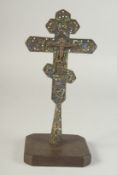 A FINE 18TH CENTURY GREEK OR RUSSIAN ENAMELLED WHITE METAL CROSS, 26cm high, on a later wooden