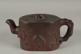 A LARGER CHINESE YIXING TEAPOT, relief decorated with flora and naturalistic forms, base with