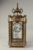 A 19TH CENTURY FRENCH BRONZE FOUR GLASS CLOCK with urn finial and twist column sides. 1ft 10ins