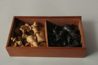 A TRAVELLING CHESS SET in a mahogany case.